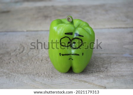 Anxious facial expression drawn green pepper. Green pepper with nervous expression. green pepper stuck in the forest and restless.