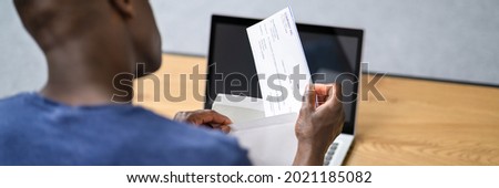 African Opening Payroll Cheque. Salary Payment Check Royalty-Free Stock Photo #2021185082