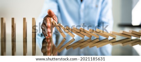 African American Business Man Domino Stop And Prevention Royalty-Free Stock Photo #2021185631