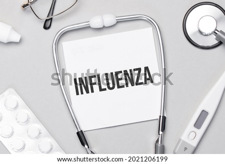In the notebook is the text Influenza stethoscope, pills, and glasses.