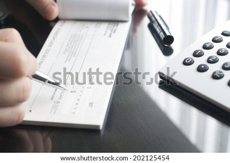 Business woman prepare writing a check Royalty-Free Stock Photo #202125454