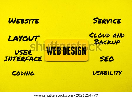 Business concept.Text WEB DESIGN writing on colored wooden board on a yellow background.