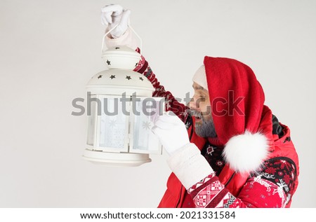 New Year and Christmas concept. Santa Claus holds a lantern in his hands.
