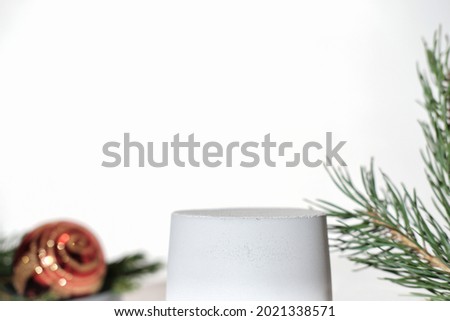 concrete or cement podium for product presentation. pedestal or display for advertizing. variety of pine branch and christmas ball. Scene with geometrical forms. Empty showcase. eco friendly design.