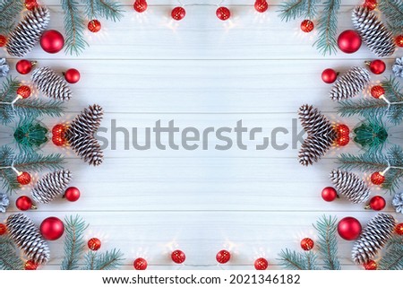 Composition with decorated Christmas tree on white rustic wooden background with copy space for text. New Year Frame for Text. Top view.