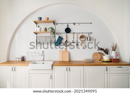 New Modern white light interior of kitchen with white furniture, dining table.Minimal style of kitchen interior design background Royalty-Free Stock Photo #2021349095