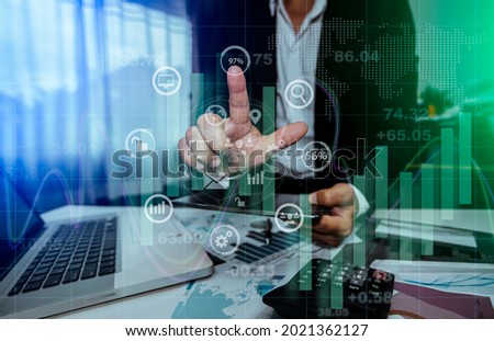 Double exposure of businessman hand touching on business financial virtual chart, Digital business stock market concept, Blurred background.