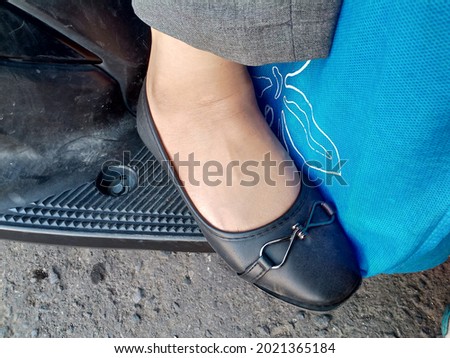 woman's feet wearing black shoes photo