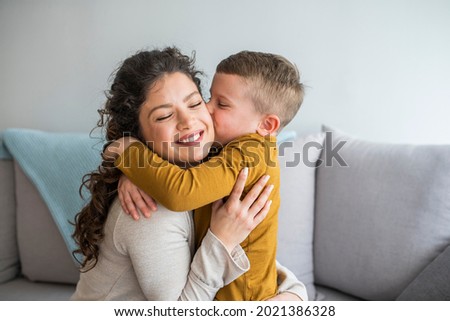 Son is kissing his mother. Mom and son. Happy mother's day! Mother hugging her child. Shot of an adorable little boy affectionately kissing his mother at home Royalty-Free Stock Photo #2021386328