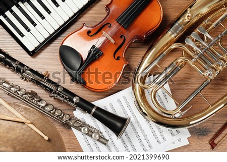 Set of different musical instruments on wooden background, flat lay Royalty-Free Stock Photo #2021399690