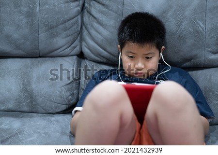kid watching tablet, boy addicted cartoon
