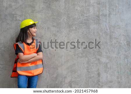 Asian Kid girl wearing reflective shirts and a hat yellow. To learning and enhance development, little architect.