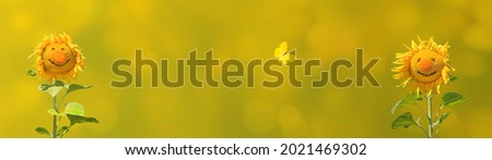 Funny sunflowers with yellow butterfly look like a couple in love on summer background as concept good summer mood for positive advertising.