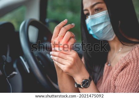 a woman sitting in a car She held it to the palm of her hand as she felt pain and numbness in her nerves after experiencing side effects from the COVID-19 vaccination.