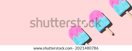 Pink and blue popsicles with shadow - flat lay