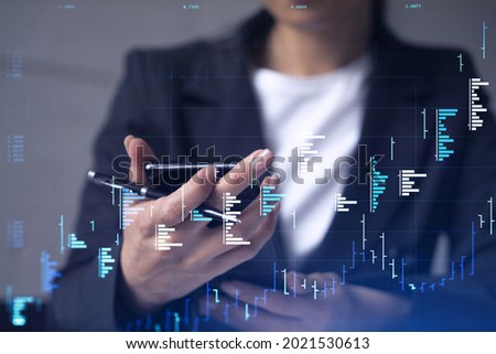 A woman trader holding in the hands a smart phone and researching stock market to proceed right investment solutions. Internet trading and wealth management concept. Hologram Forex chart.