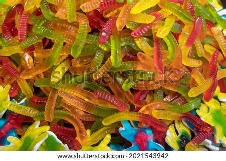 Colorful jelly candies in the form of worms. Candy background.