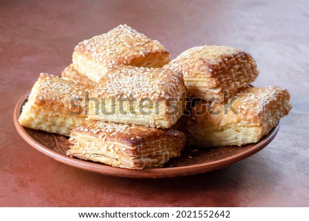 Gata or Kyata is a common Turkish, Armenian, Azerbaijani and Eastern sweet, which is a pie stuffed with butter and powdered sugar, sprinkled with sesame seeds. Royalty-Free Stock Photo #2021552642