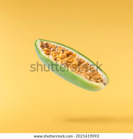 Fresh ripe exotic curuba falling  in the air isolated on yellow background