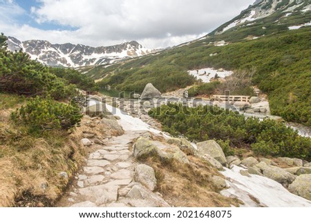 The Valley of the Five Polish Ponds in the High Tatras at the beginning of June, partially covered with remnants of snow. Poland