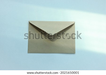 one envelope on a white background with highlights from the window