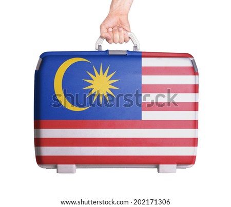 Used plastic suitcase with stains and scratches, printed with flag, Malaysia