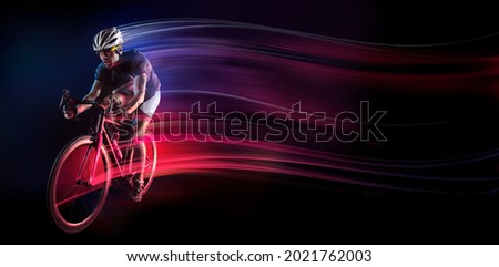 Spost background with copyspace. Cyclist. Dramatic colorful portrait. Speed and powerfull. Royalty-Free Stock Photo #2021762003