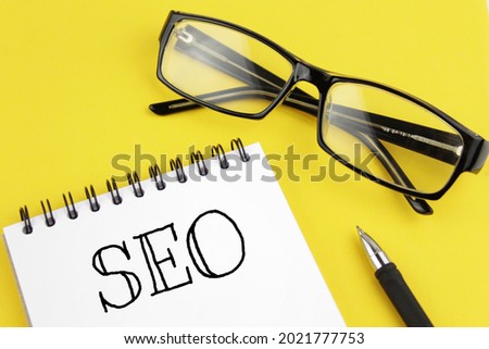 blank paper with inscription seo on a yellow background. Search engine optimization