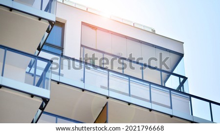 New apartment building with glass balconies. Modern architecture houses by the sea. Large glazing on the facade of the building. Royalty-Free Stock Photo #2021796668