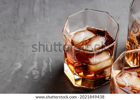 whiskey glass on a concrete background with copy space. alcohol addiction concept.