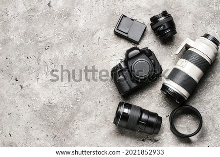 Modern photographer's equipment on grunge background