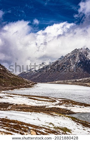 snow cap mountains with frozen lake and bright blue sky at morning from flat angle image is taken at sela tawang arunachal pradesh india. Royalty-Free Stock Photo #2021880428