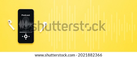 Podcast icon. Audio equipment with microphone, sound headphones, podcast application on mobile smartphone screen. Radio recording sound voice on yellow background. Broadcast media music concept Royalty-Free Stock Photo #2021882366