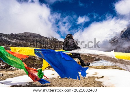 isolated young girl at mountain top with Buddhist flags at day image is taken at sela pass tawang arunachal pradesh india. Royalty-Free Stock Photo #2021882480