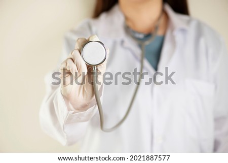 Close-up of female doctor home visit using stethoscope checking on patient , focus on stethoscope. Royalty-Free Stock Photo #2021887577