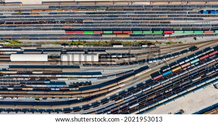 Aerial top view Passenger and freight trains on the railway station for transportation background. wagons with goods on railroad. Royalty-Free Stock Photo #2021953013