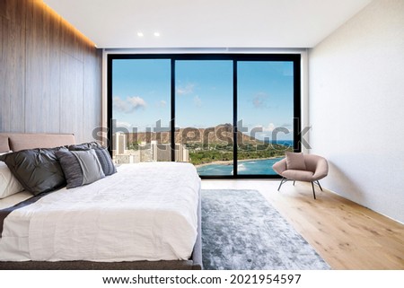 Modern and luxurious hotel bedroom with views of Waikiki beach and skyline in Honolulu, Hawaii. Condo or 5-star upscale accommodation. Royalty-Free Stock Photo #2021954597