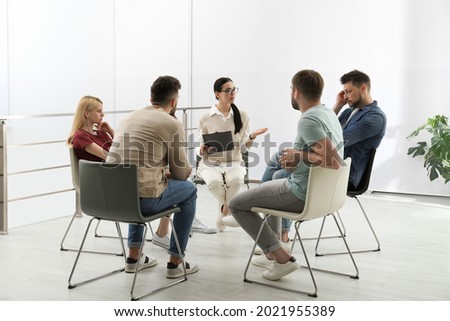 Psychotherapist working with group of drug addicted people at therapy session indoors Royalty-Free Stock Photo #2021955389