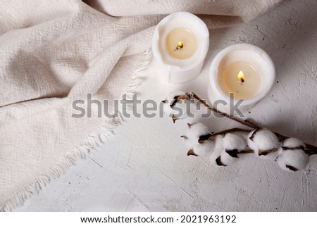 Spa relax background with candles and cotton, autumn mood, white cute picture, cosy autumn background