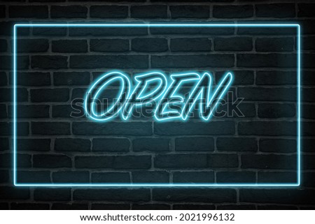 A neon open sign on a wall
