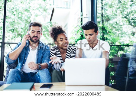 Freelancer making international consultancy conversation during collaborative meeting with remote colleagues, skilled IT professionals browsing web page while creating graphic design on laptop
