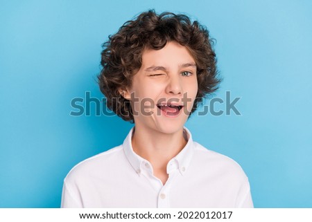 Photo of tricky pretty schoolboy wear white shirt smiling winking isolated blue color background Royalty-Free Stock Photo #2022012017