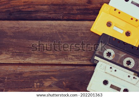 Cassette tapes over wooden table. top view. 