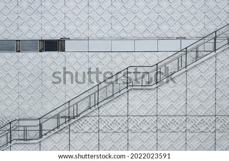 Architectural photo showing a staircase on a white geometric background
