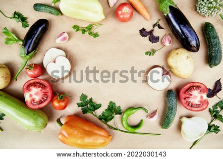 Vegetable frame: beet, basil, eggplant, parsley, bell pepper, hot pepper, potatoes, cucumber, carrots. Italian vegetable recipe. Veganism concept food.Top view, copy space. High quality photo