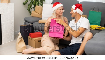 couple with gifts at christmas.