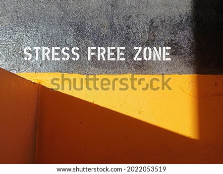 cement background with text inscription STRESS FREE ZONE ,concept of vital area of relaxation, feel free or let go of all pressures