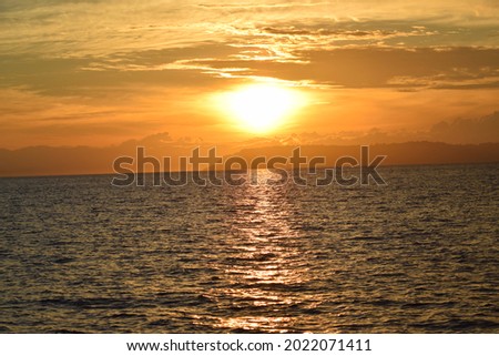 PAMULANG, INDONESIA- AUGUST 9 2021: BEAUTIFUL VIEW OF SUNSET OVER THE MOUNTAIN AND SEA