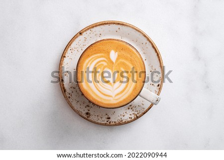 Top view of tasty cappuccino cup stand on gray stone table.  Royalty-Free Stock Photo #2022090944