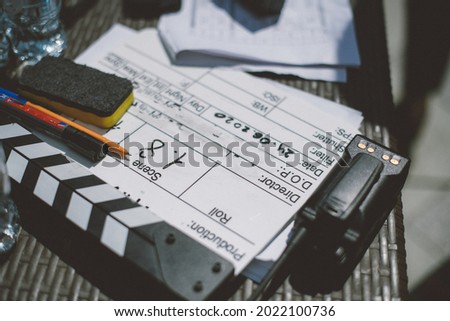 Assistant director with clapperboard on set. Close-up of firecrackers for filming a movie, advertising, TV series. Modern photography technique.